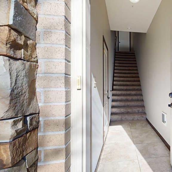 Thumbnail 2 of 22 a private front door leading into an entryway staircase and interior door to the attached garage