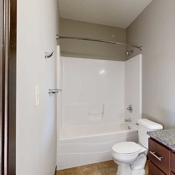 Thumbnail 21 of 22 a bathroom with a shower and granite countertop vanity sink