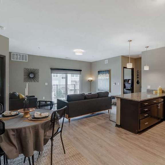 Thumbnail 3 of 17 A modern kitchen with dark wood cabinets and a dining table set for two