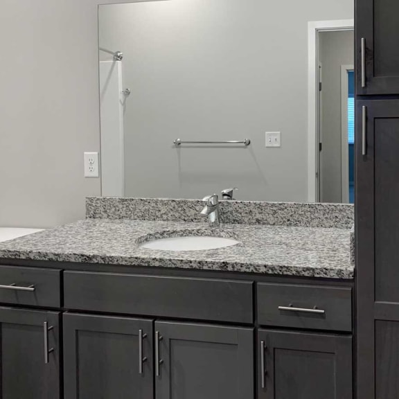 Thumbnail 8 of 13 a bathroom with a sink and a toilet and a mirror