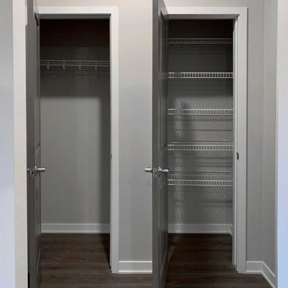 Thumbnail 10 of 13 a room with a closet and a door to a closet