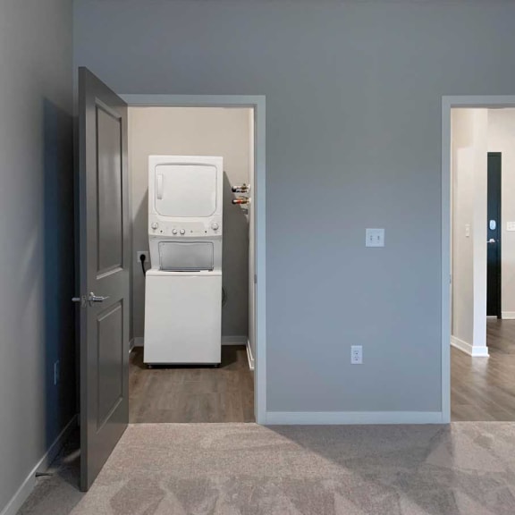 Thumbnail 6 of 13 a white washer and dryer in a room with a door