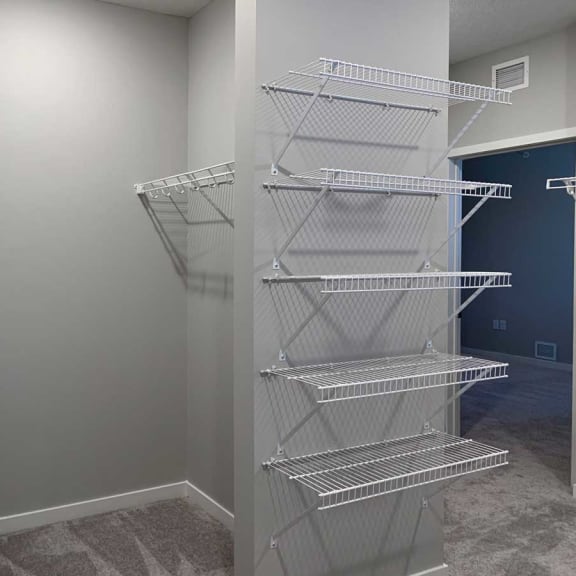 Thumbnail 12 of 13 a walk in closet in a home with a mirrored closet door