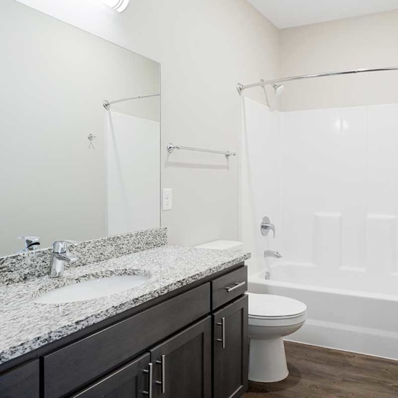 Thumbnail 18 of 19 a bathroom with granite countertop sink and a shower