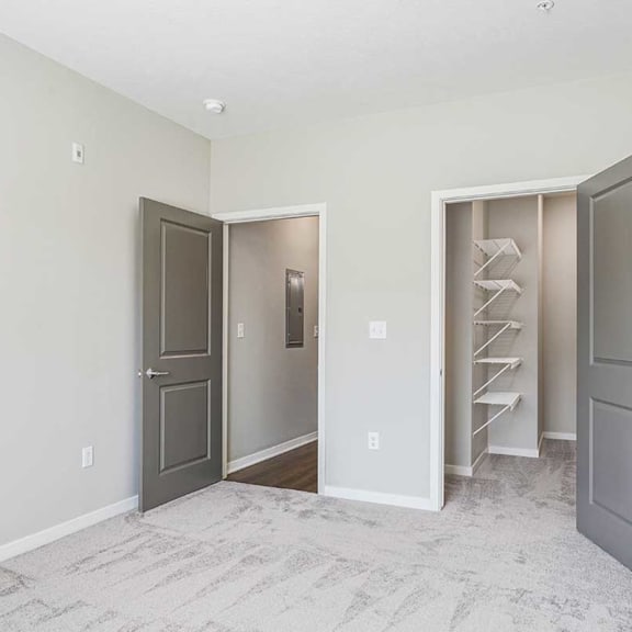 Thumbnail 13 of 19 a bedroom with an attached walk-in closet
