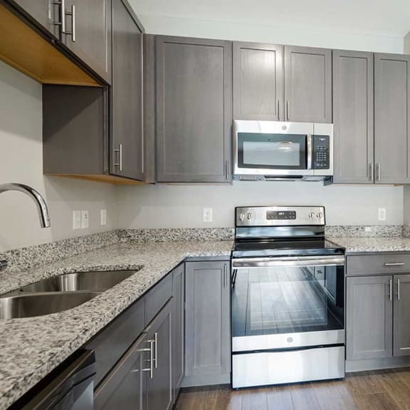 Thumbnail 5 of 19 a kitchen with stainless steel appliances and granite counter tops