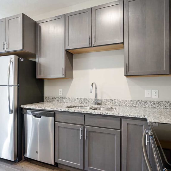 Thumbnail 6 of 19 a kitchen with stainless steel appliances and grey cabinets