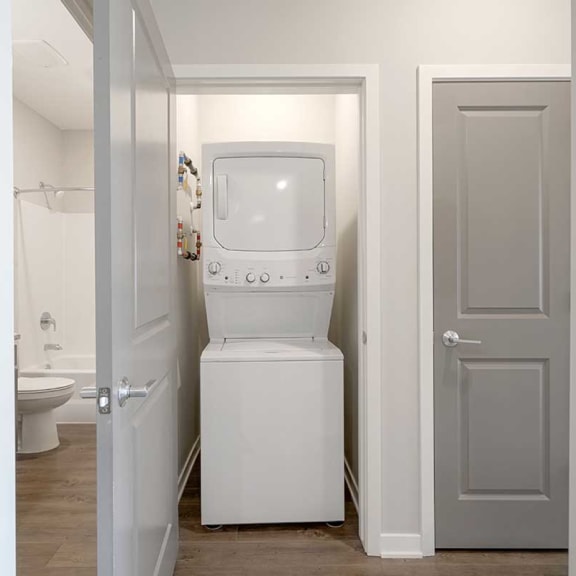 Thumbnail 16 of 19 a stackable washer and dryer in a closet
