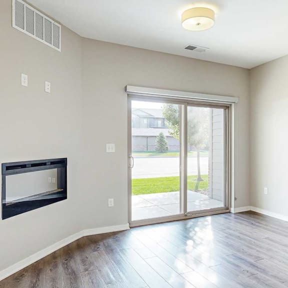 Thumbnail 8 of 19 a living room with a fireplace and a sliding glass door