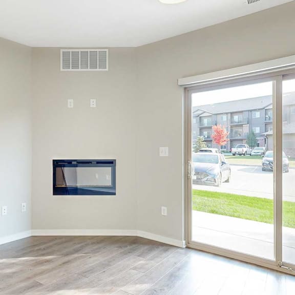 Thumbnail 10 of 19 a living room with a fireplace and a sliding glass door