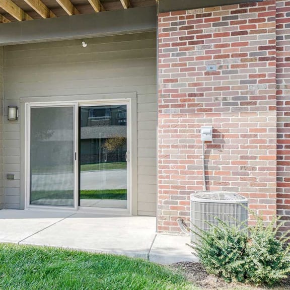 Thumbnail 9 of 19 the sliding glass door of a first floor Lilac apartment with a patio space