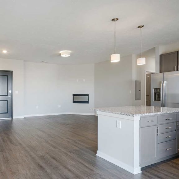 Thumbnail 8 of 27 an open-concept living room and kitchen area with hard wood flooring and a fireplace