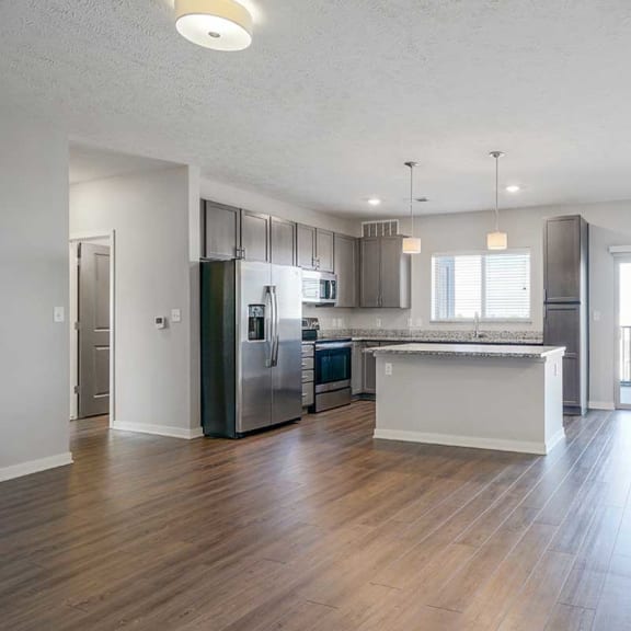 Thumbnail 4 of 27 an open kitchen, dining room and living room space with luxury vinyl hardwood floors