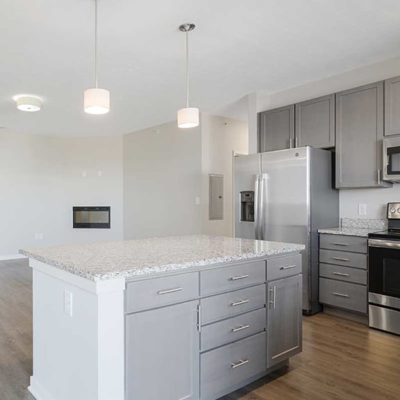 Thumbnail 7 of 27 an open kitchen and living room with a large island