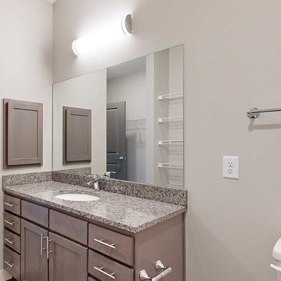 Thumbnail 18 of 29 a bathroom with a large vanity sink with granite countertop and a medicine cabinet