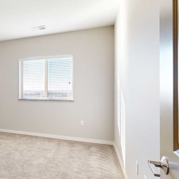 Thumbnail 24 of 29 a bedroom with a large window and carpeting