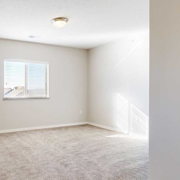 Thumbnail 16 of 29 a bedroom with a window and carpeting