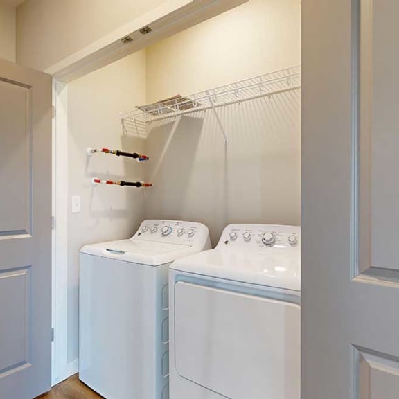 Thumbnail 29 of 29 a laundry room with a full-sized side-by-side washer and dryer and overhead storage