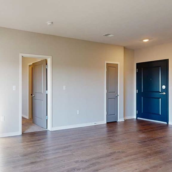 Thumbnail 14 of 29 a living room with a fireplace and a door into the primary bedroom