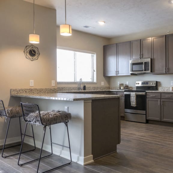 Thumbnail 3 of 8 Large kitchen with stainless-steel appliances and peninsula at WH Flats new luxury apartments in south Lincoln NE 68516
