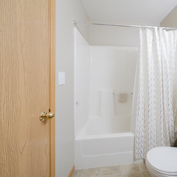 Thumbnail 18 of 20 a bathroom with a shower tub combo and a toilet and a sink