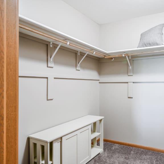 Thumbnail 16 of 20 a walk in closet with shelves