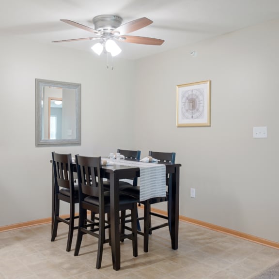 Thumbnail 4 of 20 a dining room with a table and chairs and a ceiling fan