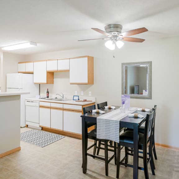 Thumbnail 6 of 20 a kitchen and dining room with a table and chairs