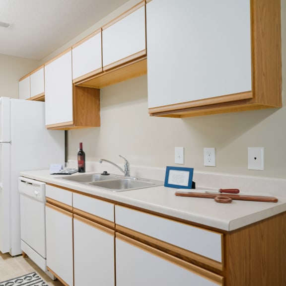Thumbnail 8 of 20 Traditional kitchen with white cabinets, a dishwasher, a sink and a refrigerator