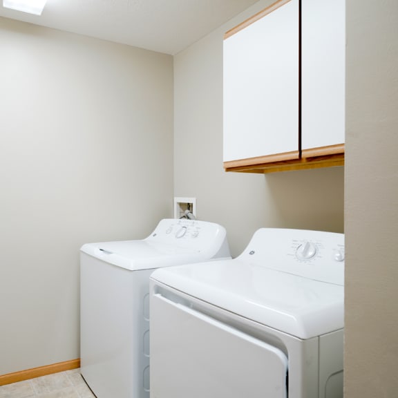 Thumbnail 19 of 20 the laundry room has a washer and dryer and cabinet for storage