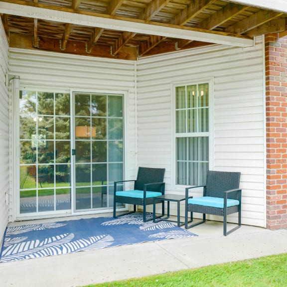 Thumbnail 20 of 20 Back patio with two chairs and a rug in front of sliding glass door