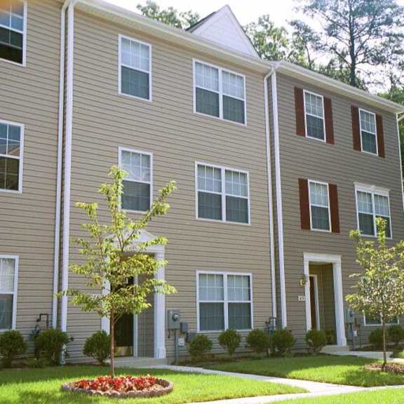 a large apartment building with trees in front of it