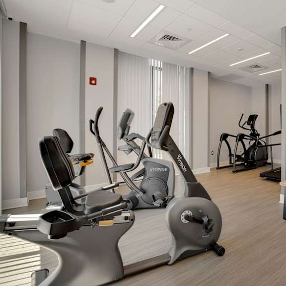 a room filled with exercise equipment and a bench