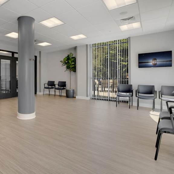 a large room with chairs and a tv on the wall