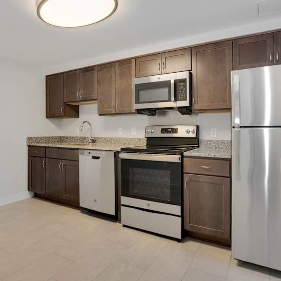 a kitchen with wooden cabinets and stainless steel appliances