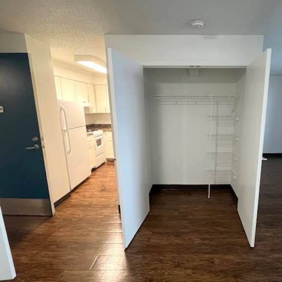 a room with a white door and a brown floor.