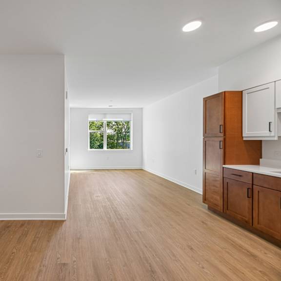 a room with wooden floors and white walls.