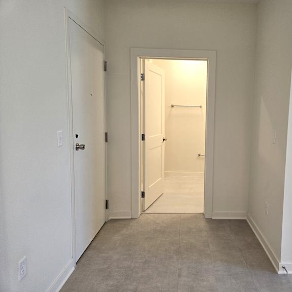 a white room with a doorway leading to another room.