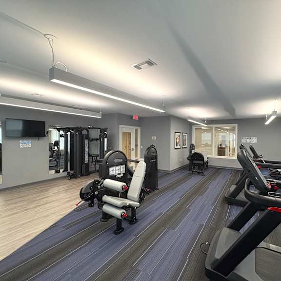 a gym with treadmills and exercise equipment.