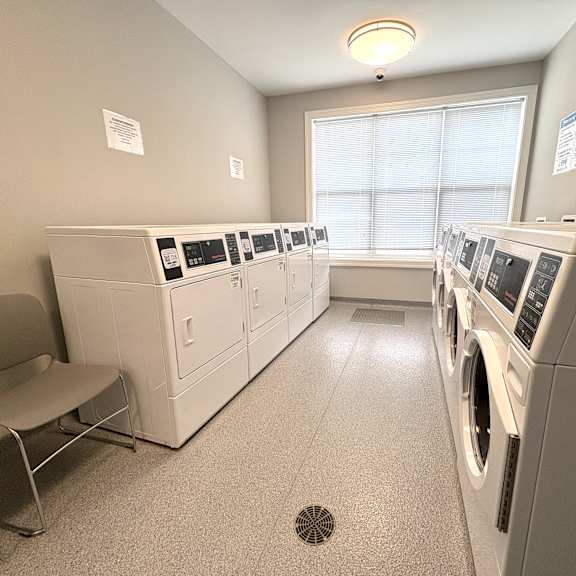 a laundry room with washers and dryers.