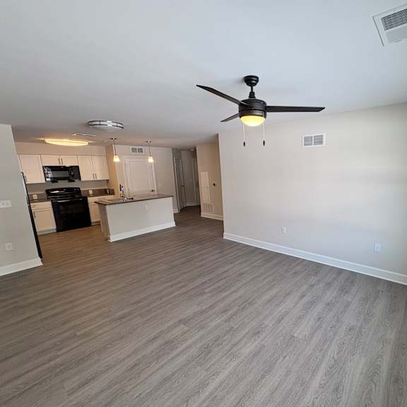 a room with a ceiling fan and light fixture.