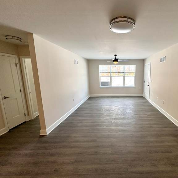 a room with a window and a light fixture on the ceiling.