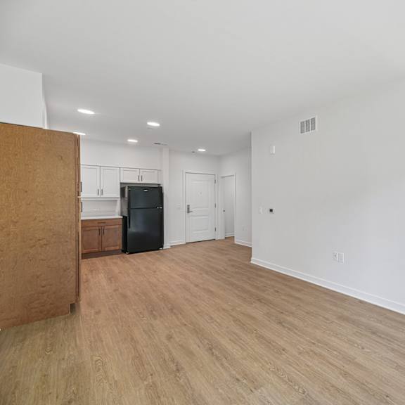a room with a wooden floor and white walls.