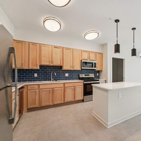 a kitchen with wooden cabinets and a white island.