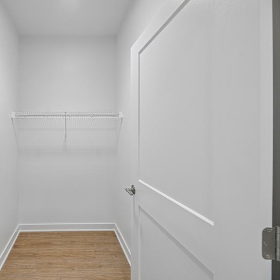 a white hallway with a door on the right.