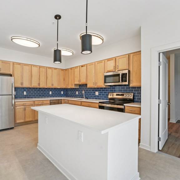 a kitchen with wooden cabinets and a white island.