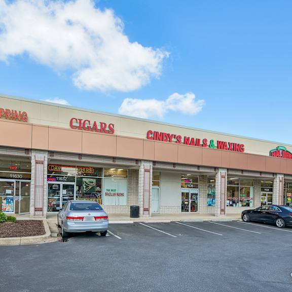 a cigar store with cars parked in front.