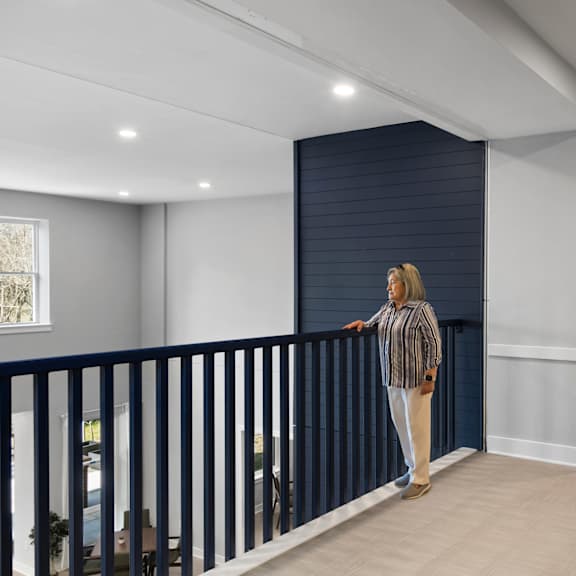 a hallway with white walls and a blue wall with mannequins in it