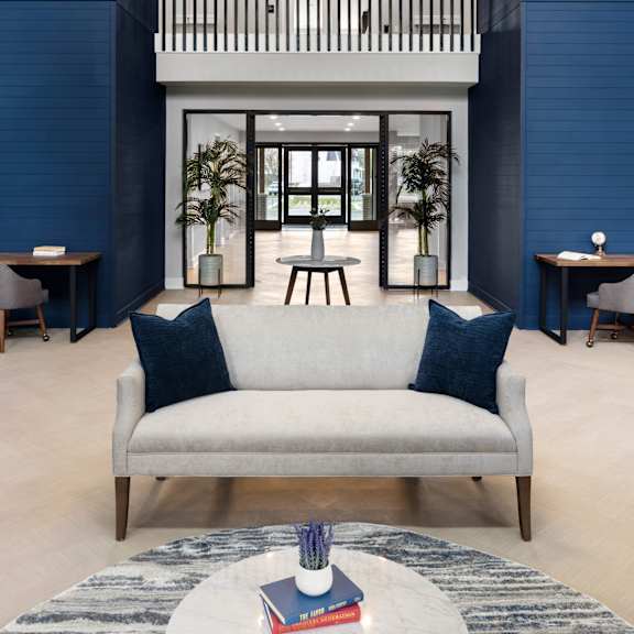 a living room with blue walls and a white couch