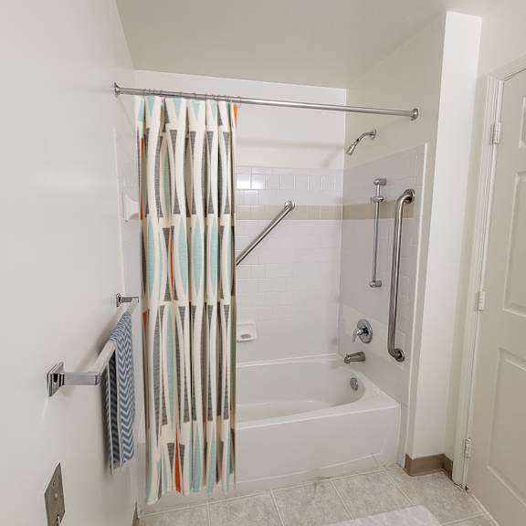 a bathroom with a toilet sink and bathtub in a 555 waverly unit